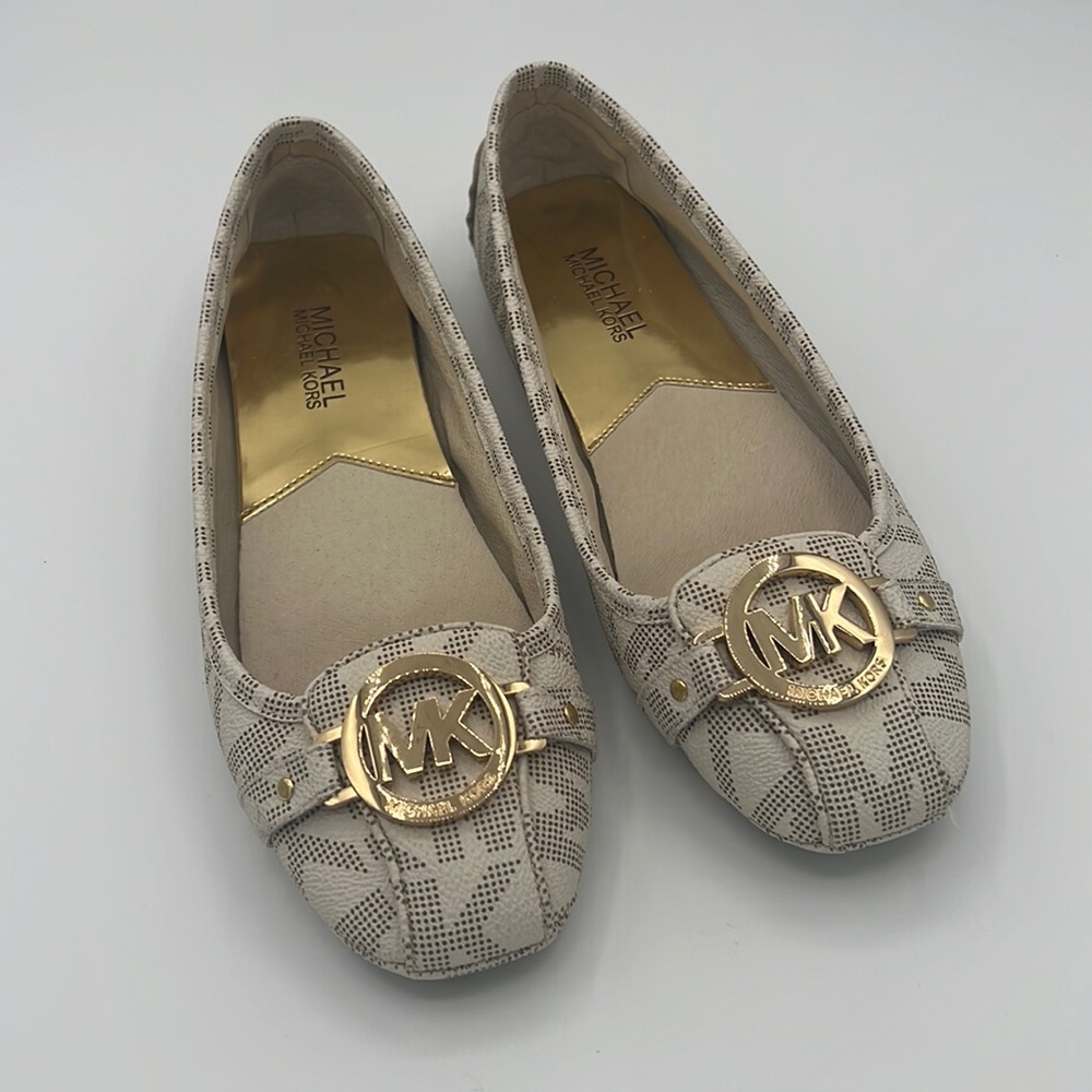 Michael Kors round toe slip on flat shoe with gold logo hardware at toe $70